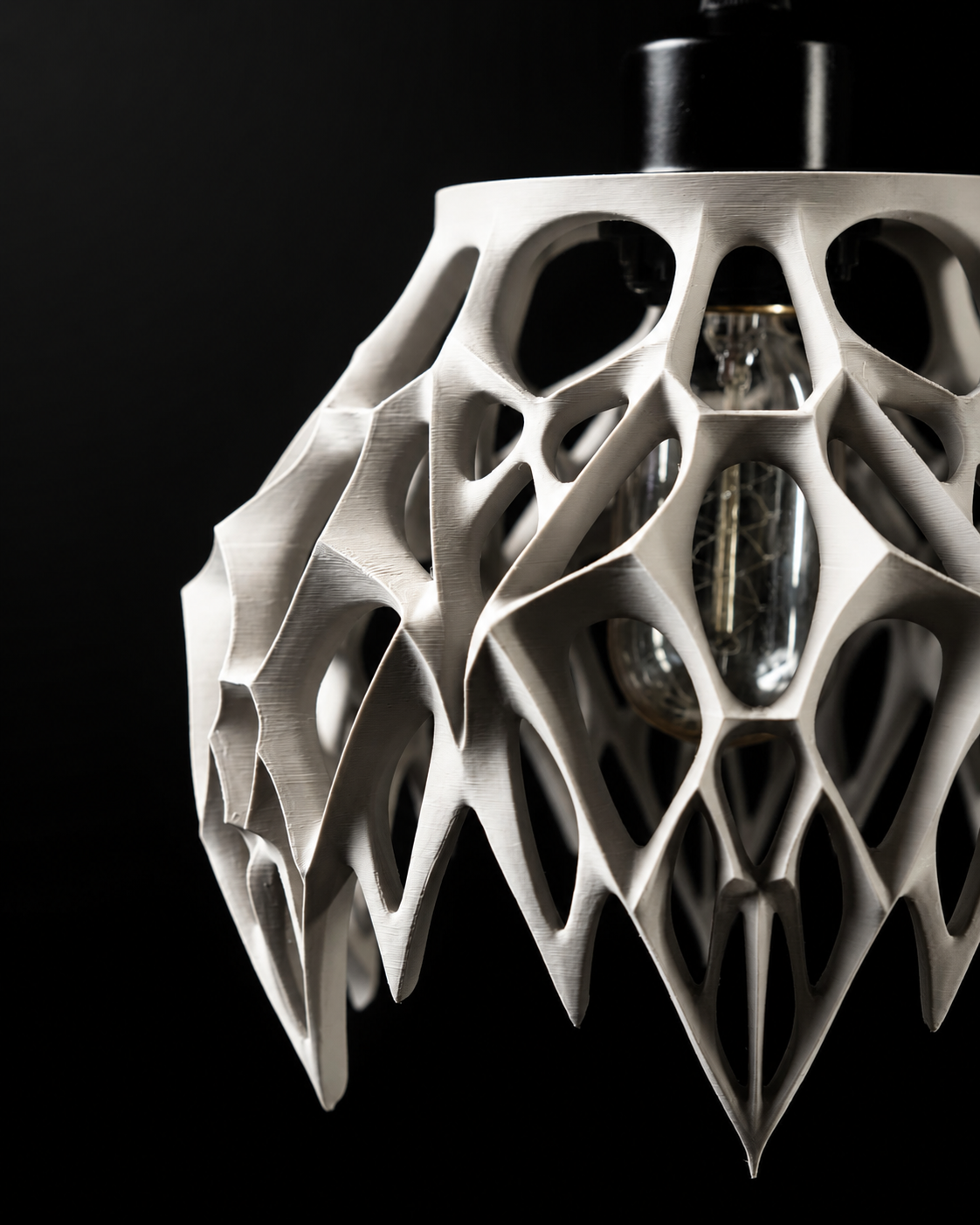 Angled close-up of the Arachne pendant lamp's sculptural lattice