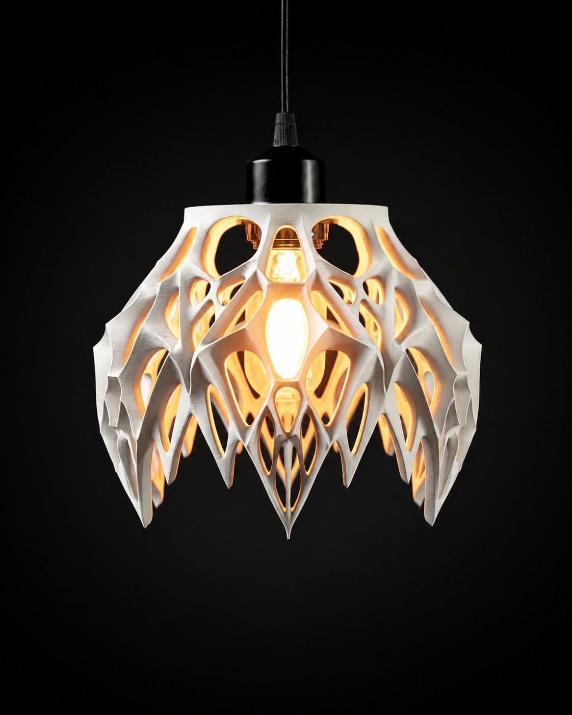 Arachne pendant lamp illuminated against a black background