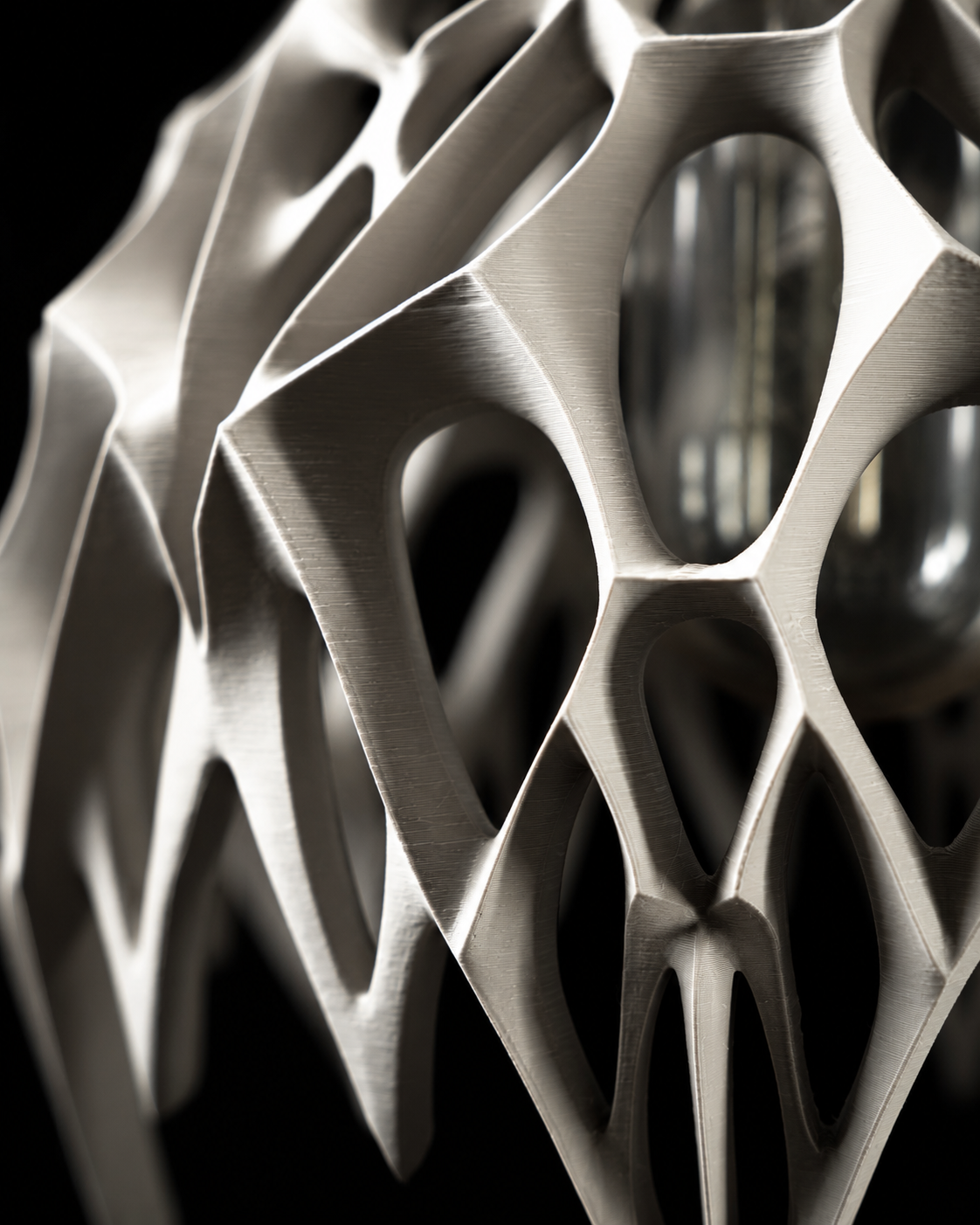 Detail of the Arachne pendant lamp's organic web-like texture
